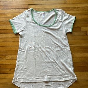 Lularoe classic T Shirt. Size Extra Small. Beige and green trim. Knit fabric